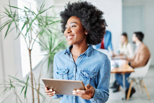 portrait of a smiling young businesswoman holding a tablet in the office